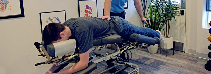 Chiropractor De Pere WI Dennis Ruess Adjusting A Patient