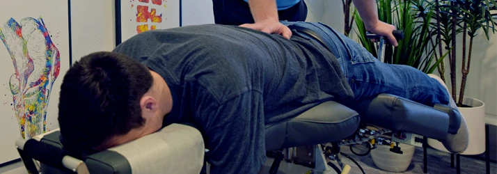 Chiropractor De Pere WI Dennis Ruess Adjusting A Patient