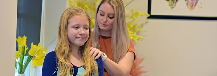 Chiropractor De Pere WI Kayla Komarec With Child Patient